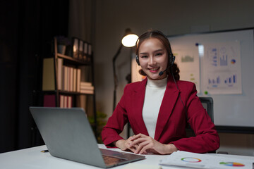 Female entrepreneur serving customers Business information, inquiries, Asian call center with headset and microphone working on laptop Customer Service Center Representative Support Help customers.
