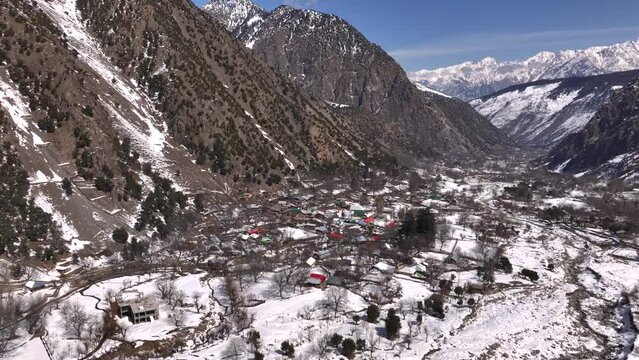 Scenic Kalasha Village in Bamburet Valley in North Pakistan at Winter. Aerial View Hindu Kush Muntain Range Himalayas.