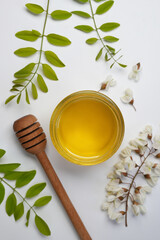 Sweet honey jar and spring acacia blossoms, top view, flat lay.