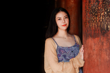 Beautiful Thai Asian women standing smiling leisure with old wooden pole in temple with blank space for text - 807762087