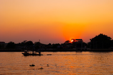 dusk dawn river view sunset orange sky. evening silhouette boat quiet calm chaophraya riverside...