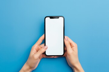 A person is holding a cell phone with a white screen. The blue background suggests a calm and peaceful atmosphere. Mockup