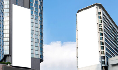 Two outdoor vertical billboard on building  with blue sky background