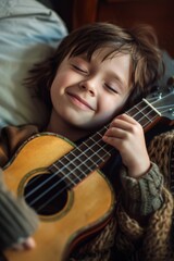 Young Boy Laying in Bed With Guitar