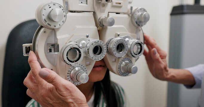 Child, machine and eye exam for vision in clinic with ophthalmology, optical assessment and healthcare service. Check for eyes, phoropter and girl patient with myopia and medical test for insurance