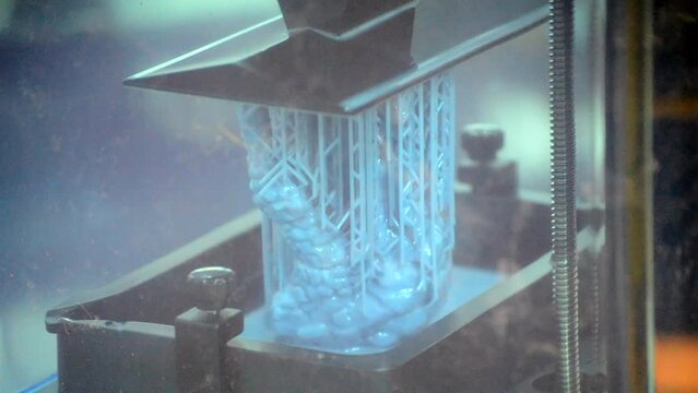 3D printer working process. 3D printing. Stereolithography photopolymerization SLA. Additive manufacturing technology. Liquid materials, hard part, creating layers. 3D model ultraviolet polymerization