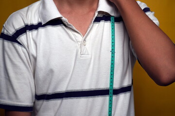 person measure the height of the upper body or shoulder isolated yellow background