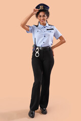 African-American female police officer on brown background