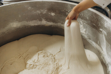 Electric dough mixer machine at the kitchen of bakery. It is mixing sourdough.