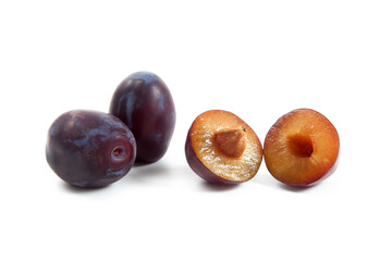 Two Whole and Halves purple plums isolated on white background. .