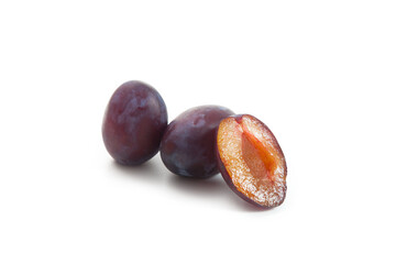 Two Whole and Halves purple plums isolated on white background. .