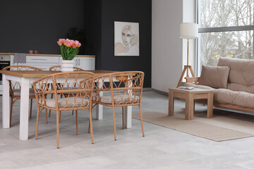 Modern interior of living room with stylish dining table and cozy sofa