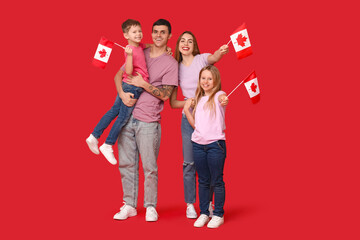 Happy family with flags of Canada on red background