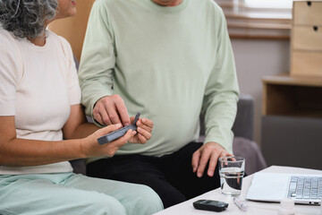 Snior wife giving daily prescription medication to her husband. Healthcare concept