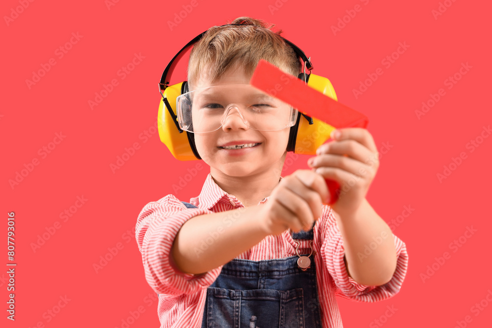 Poster cute little builder with ruler on red background