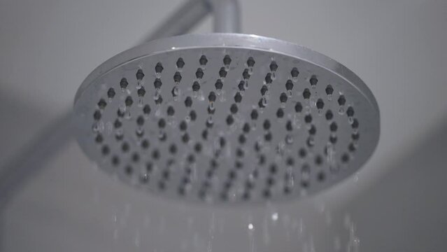 Close Up Static Shot Of Shower Head Dripping. Low Pressure Flow.