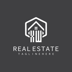 initial monogram logo for real estate with building shape creative design	
