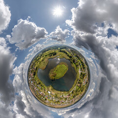 simple tiny planet without buildings in blue sky with beautiful clouds. Transformation of spherical panorama 360 degrees. Spherical abstract aerial view. Curvature of space.