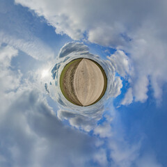 simple tiny planet without buildings in blue sky with beautiful clouds. Transformation of spherical...