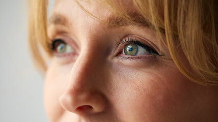 Close Up Portrait Of Woman With Nose Piercing Against Neutral Plain Studio Background