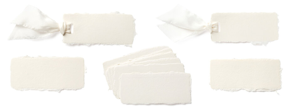 set of blank deckle edged handmade paper place cards or hangtags isolated over a transparent background, single, in a stack and with silk ribbon, mockups for wedding table settings or branding 