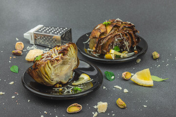 Delicious baked artichoke with parmesan cheese and pistachio. Olive oil, garlic, parsley and lemon