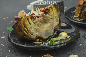 Delicious baked artichoke with parmesan cheese and pistachio. Olive oil, garlic, parsley and lemon