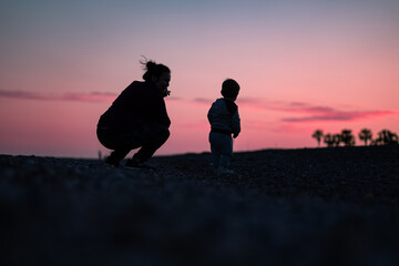 silhouettes of mother and child having a great day