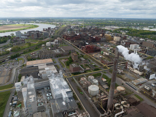 Smoking smoke stack at chemical park in the german Ruhr Area. Heavy industry, 4K Aerial drone view.