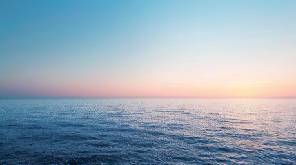 Serene ocean at dusk with clear sky and soft hues