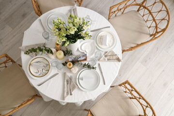 Beautiful table setting with eustoma flowers and candles for wedding celebration in room, top view