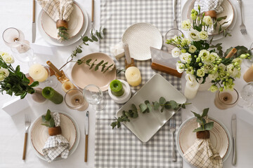 Beautiful table setting with eustoma flowers and eucalyptus for wedding celebration in room, top view