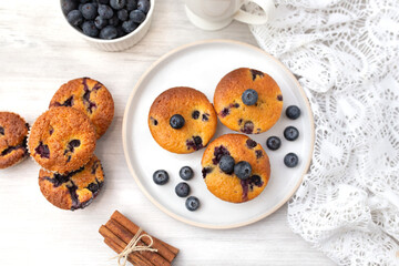 Blueberry muffins baked with fresh blueberries on a white  white background, close-up.  