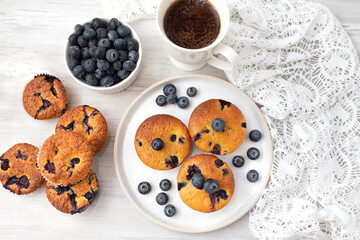 Blueberry muffins baked with fresh blueberries on a white  white background, close-up.  