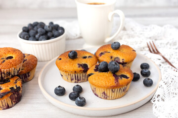 Blueberry muffins baked with fresh blueberries on a white  white background, close-up.  