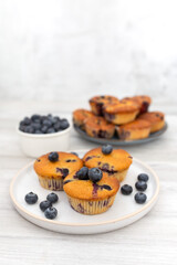 Blueberry muffins baked with fresh blueberries on a white  white background, close-up.  
