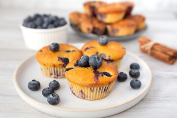 Blueberry muffins baked with fresh blueberries on a white  white background, close-up.  