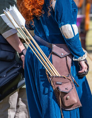 Medieval archery equipment, bow and arrow in the hands of a man