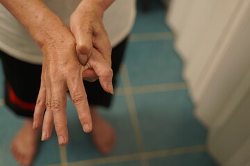 A woman uses her other hand to feel pain. and tingling along with symptoms of numbness in the hands...