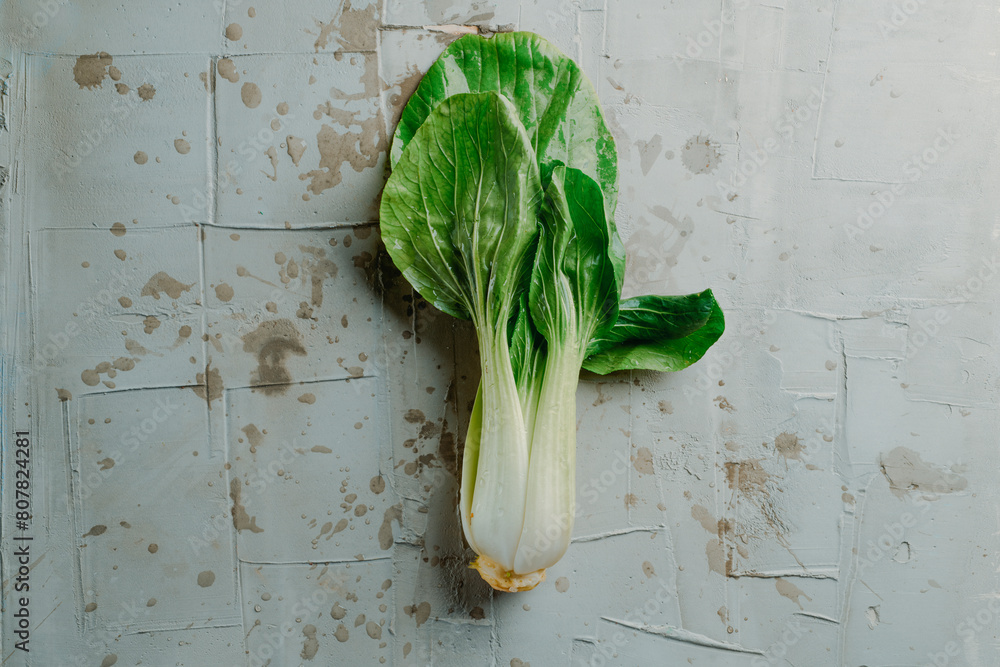 Sticker bok choy on a gray textured surface