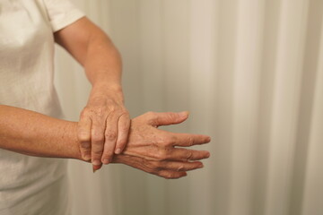 A woman uses her other hand to feel pain. and tingling along with symptoms of numbness in the hands...