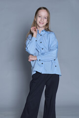 Poised young model with a self-assured posture, showcasing modern kidswear. Illustrates confidence...
