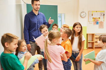 Students standing with teacher in classroom