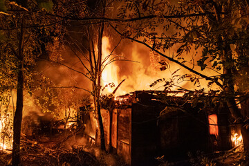 Night fire at abandoned village house and forest