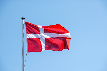Denmark flag isolated on the blue sky. flag symbols of Denmark.