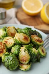 Delicious roasted Brussels sprouts on table, closeup