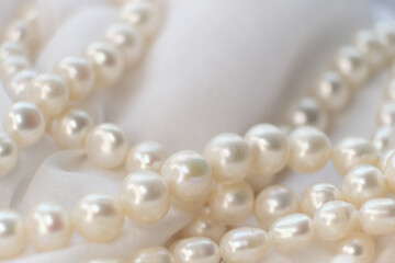The soft focus pearls on a white canvas evoke a sense of calm and timeless beauty. This tranquil...