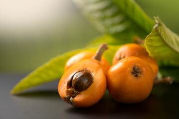 Medlar, Loquat fruit or Japanese medlars, Nispero, Eriobotrya japonica with leaves fresh ripe bio vegetarian food, medlar berries. Close up. 