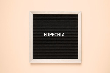 a black letter board with the word euphoria written on it