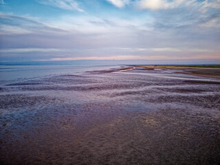 Coastal sunset scene. Aerial photograph showing tidal channels flowing through sand dunes. Lincolnshire Coast, Gibraltar Point. Summer evening sunset